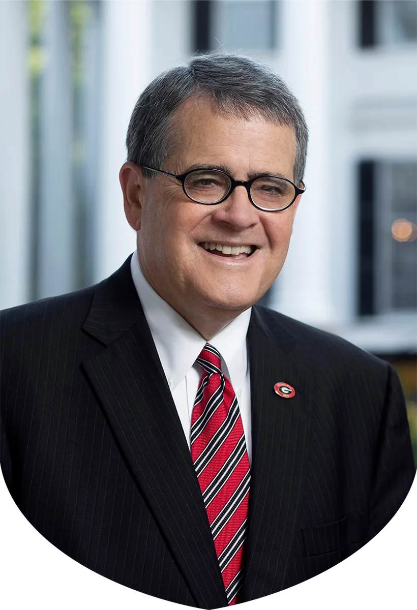 A close-up profile of Jere W. Morehead, the 22nd University of Georgia President in a black suit jacket and red and black striped tie.