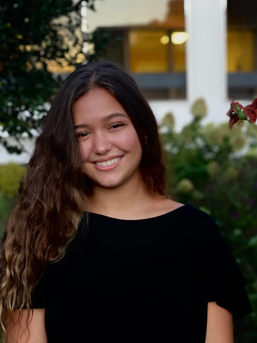 A close-up profile photo of Mariah Cady, a student at the University of Georgia. She is dressed in a black t-shirt and surrounded by greenery.