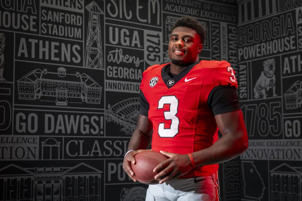 CJ Allen in his red Georgia football jersey, number 3, holding a football